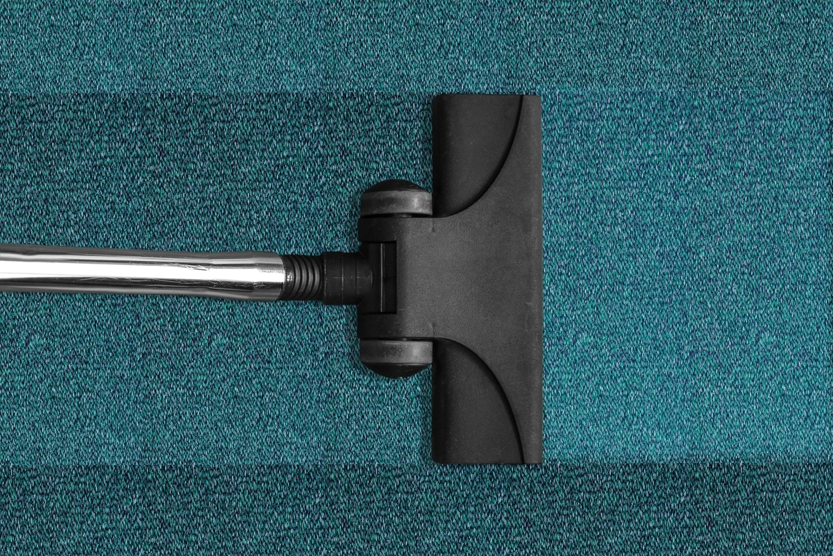 Vacuuming carpet tiles