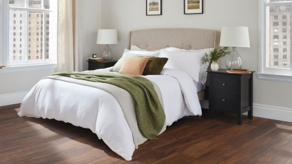 A bedroom with a natural wood design LVT